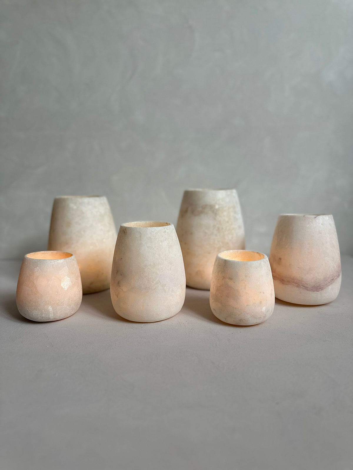 Roya the Brand alabaster vase collection glowing softly on table