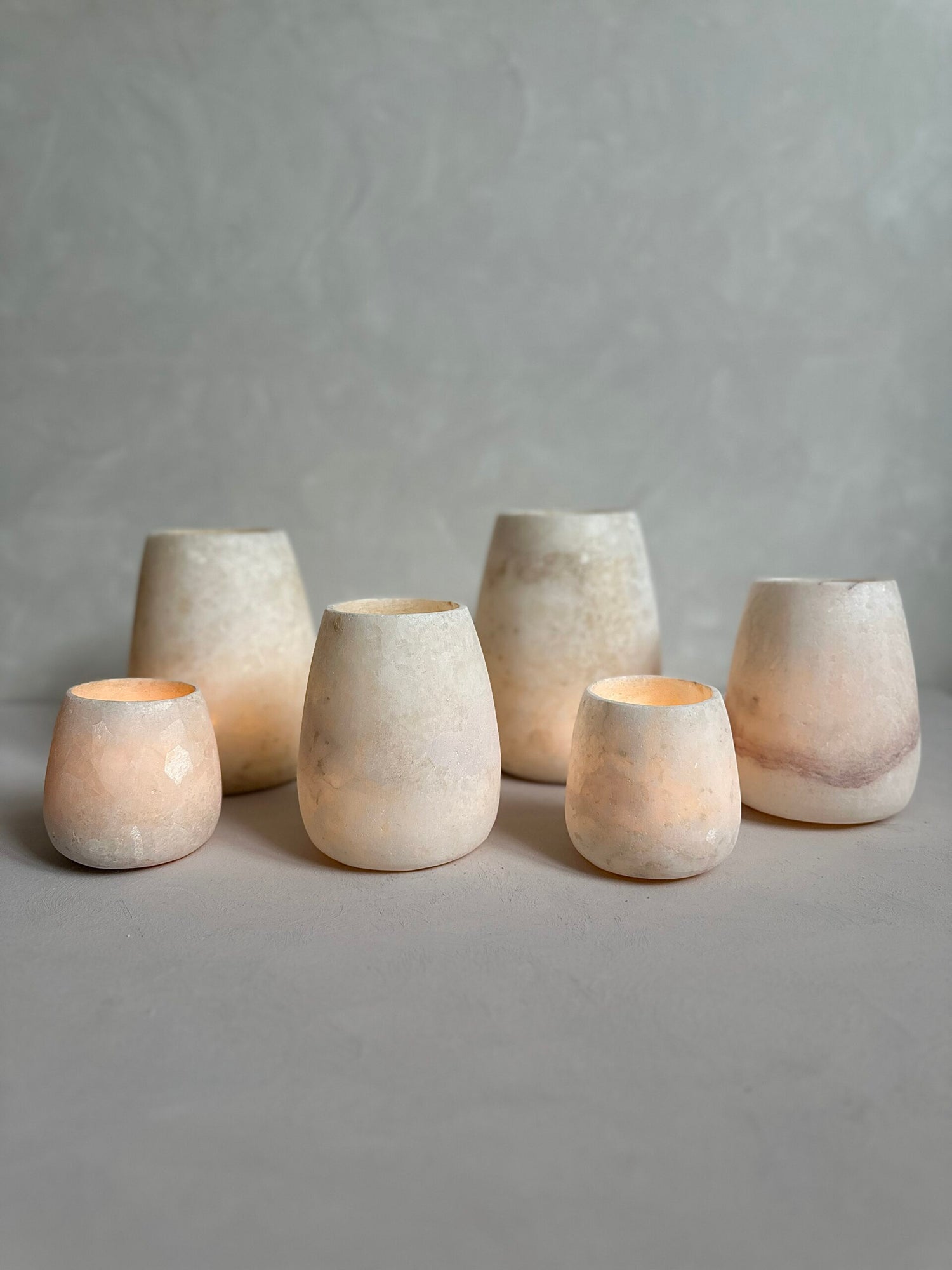 Roya the Brand alabaster vase collection glowing softly on table