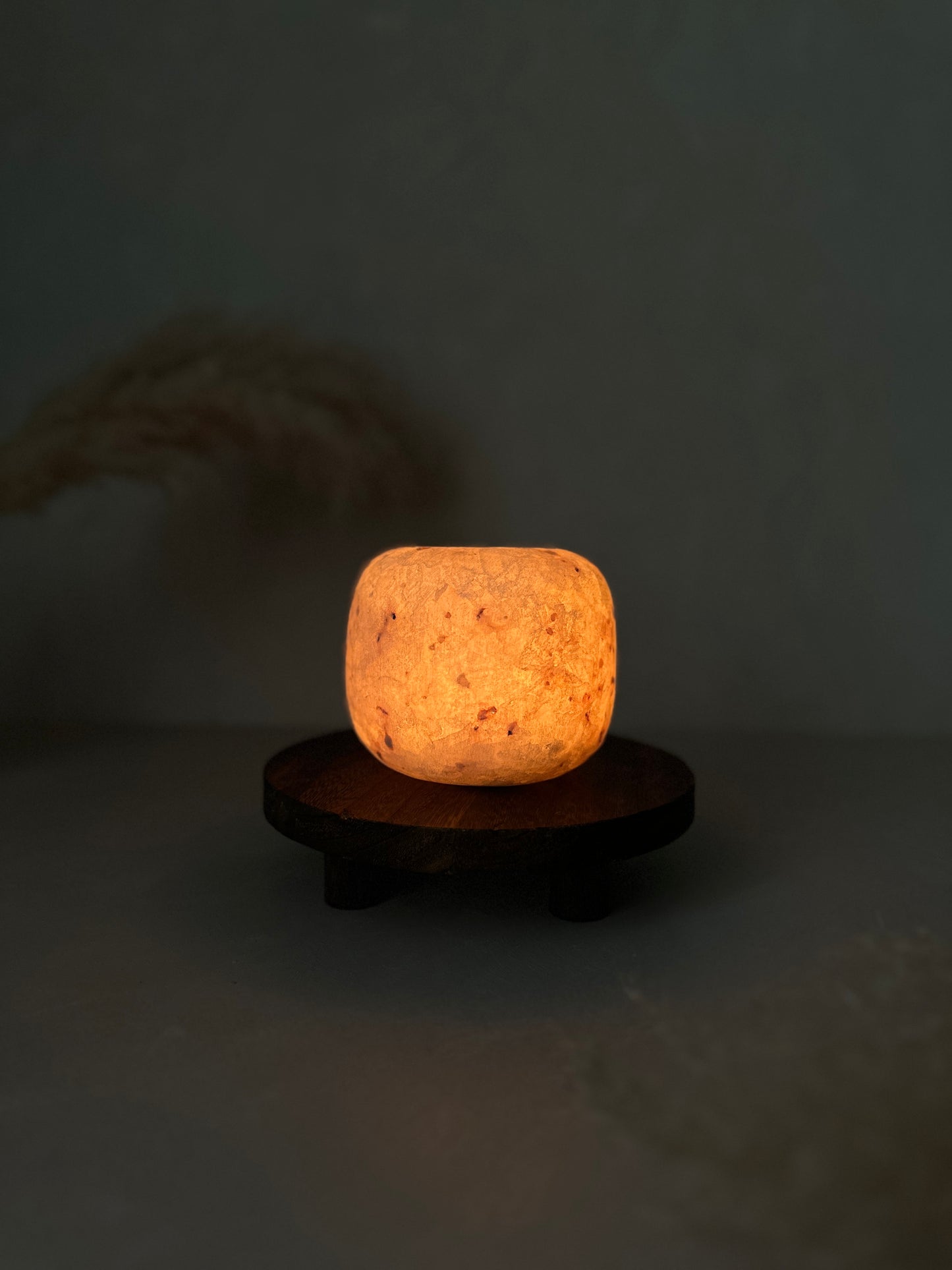 Alabaster candle holder light fixture on a dark background